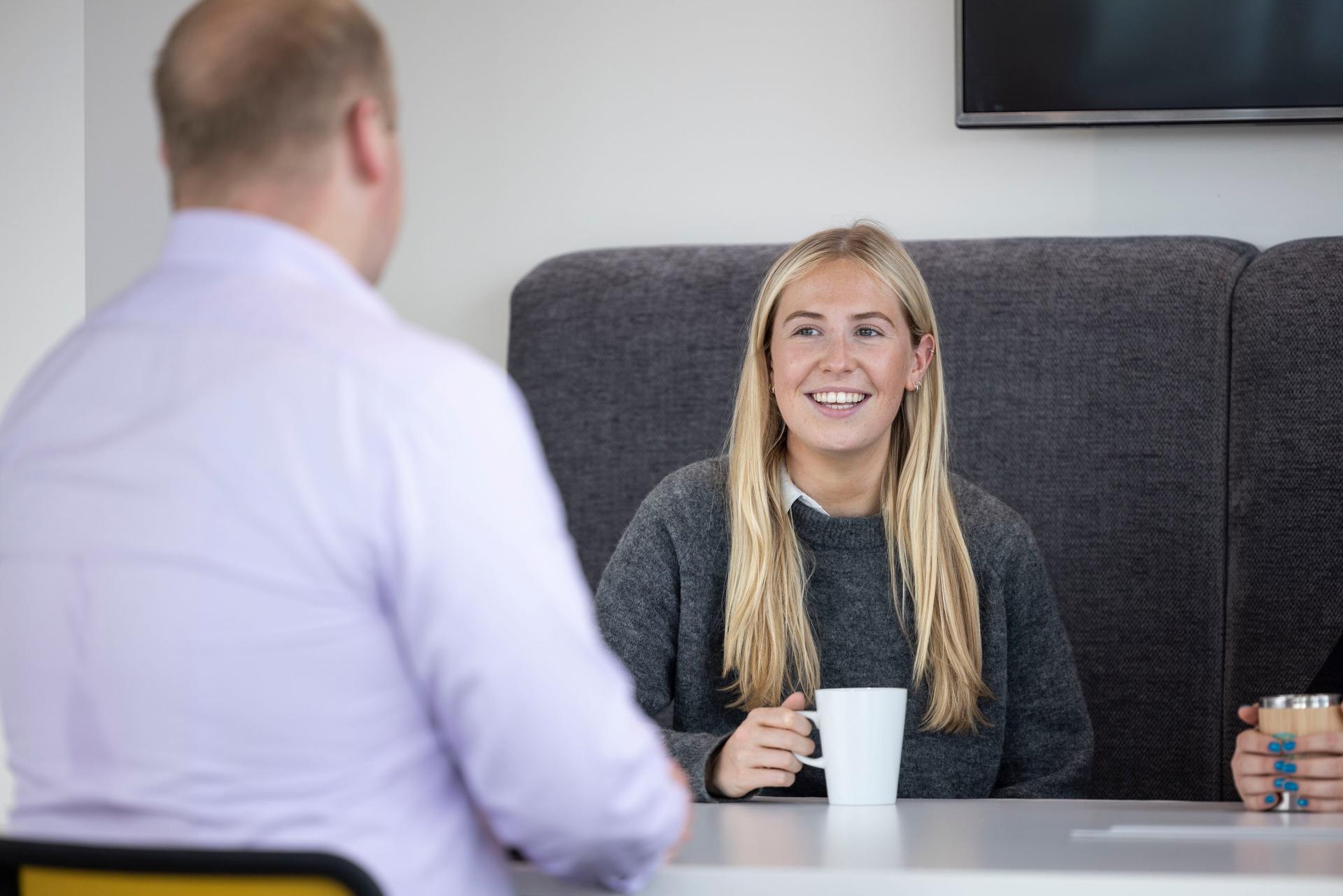 Graduates talking over a coffee in the canteen
